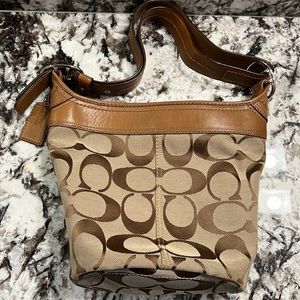 Coach handbag signature textile with leather trim.